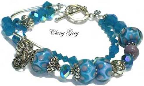 handmade Swarovski crystal bracelet with lampwork beads, blue opals and charms