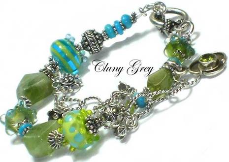 Peridot bracelet with two-tone lamp worked beads, sterling silver and charm.