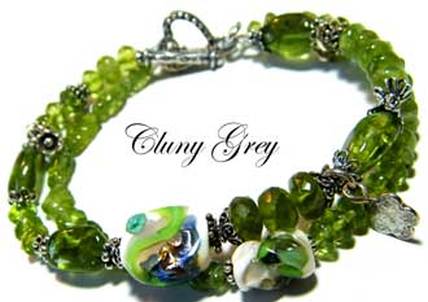 Peridot bracelet of two strands, lamp worked beads, sterling silver and carved ovals.